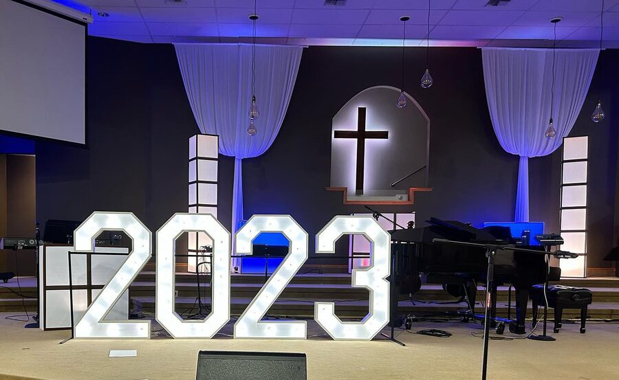 2023 in lit numbers on a church stage