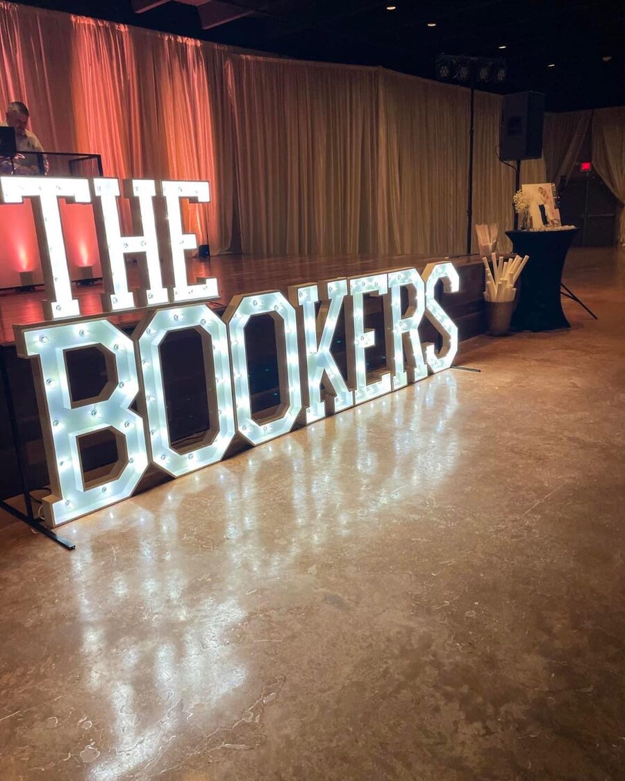 THE BOOKERS in lit letters along the edge of a reception hall